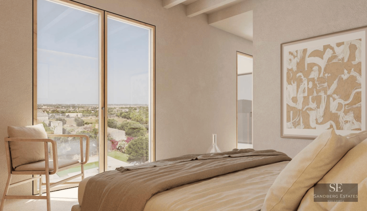 Minimalist bedroom featuring a large window with field views, exposed wood beams, and neutral beige tones.