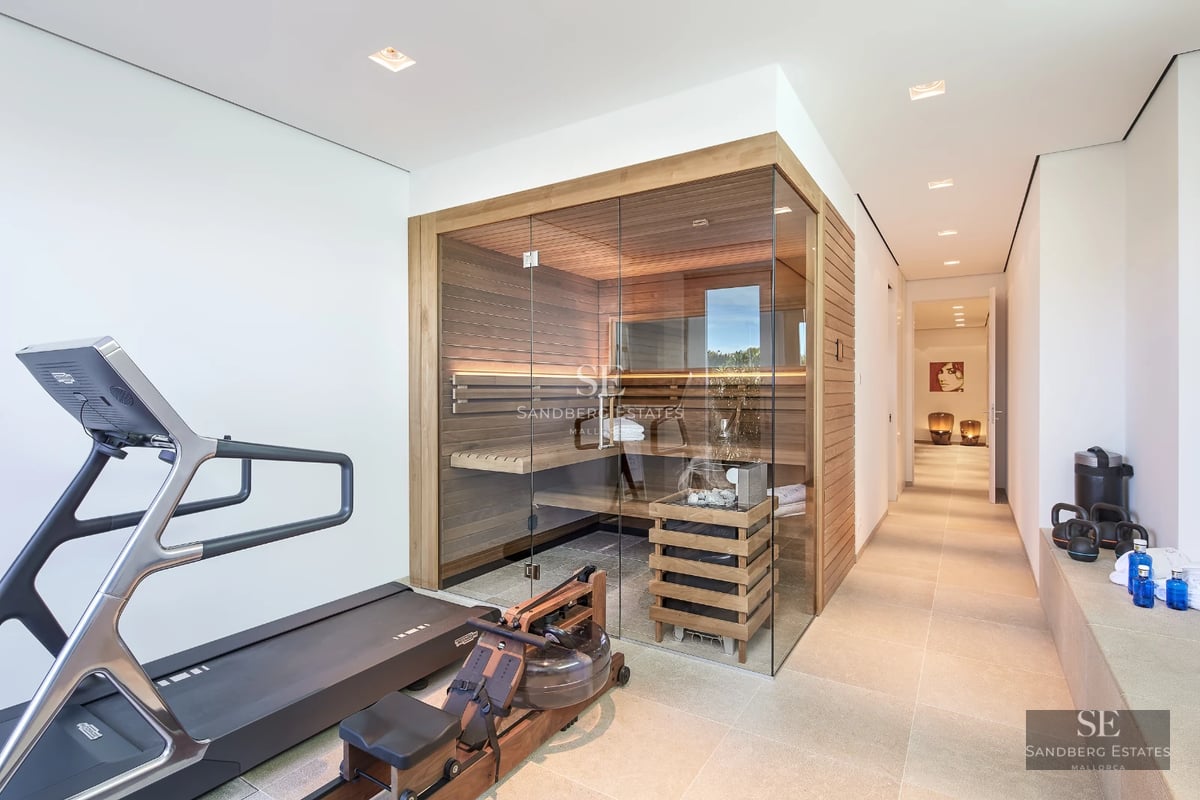 Image of a modern infinity pool with panoramic sea views. Minimalist architecture, light colors, surrounded by greenery.