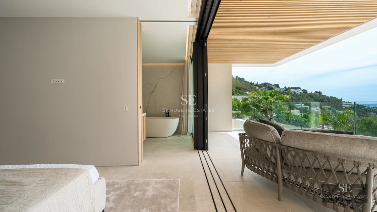 View of reflective pool with modern, minimalist design. Glass and stone facade. Lush landscaping.