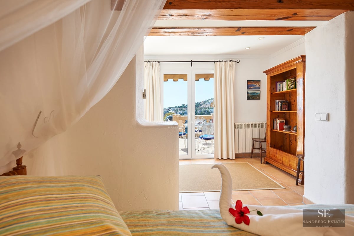 Modern apartment with sea view balcony. Stylish outdoor furniture. Minimalist design with abundant natural light.