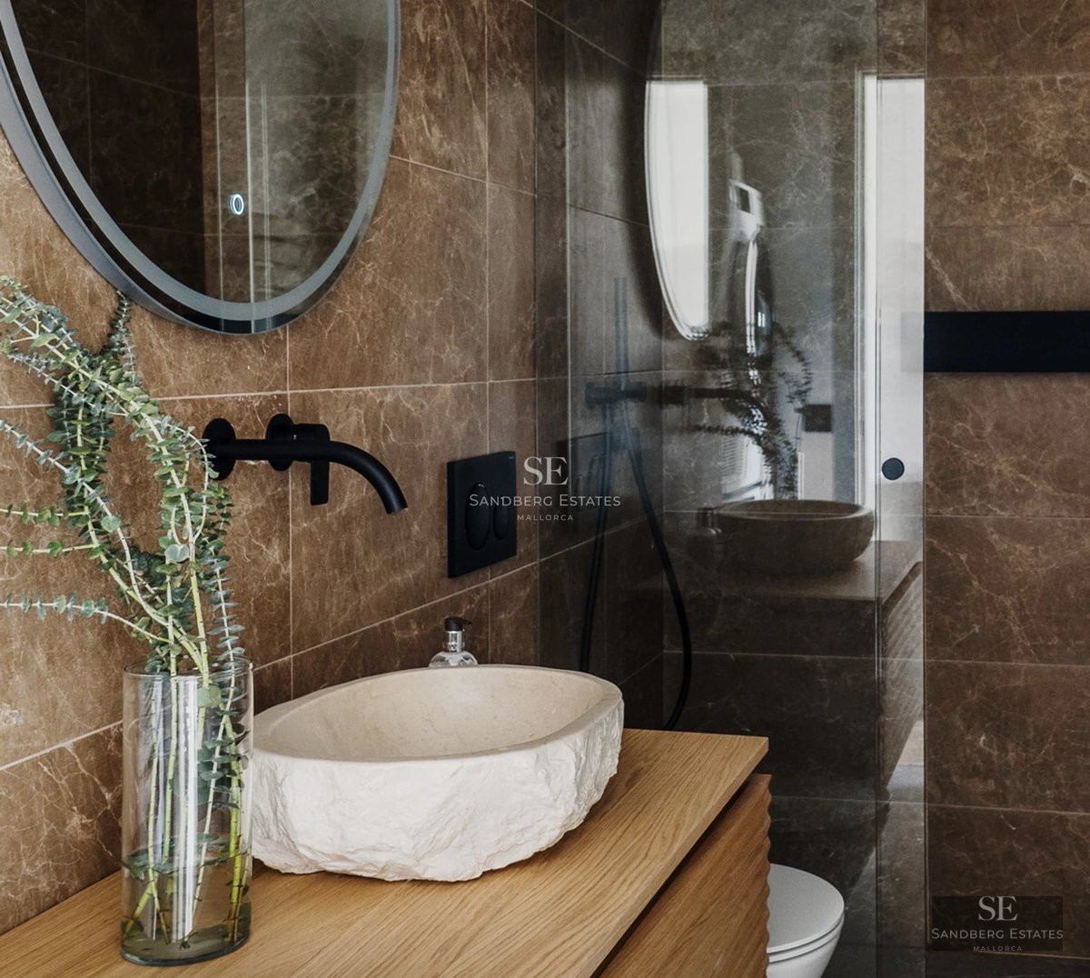 Spacious living room with panoramic sea views. Modern design with white sofas, wooden coffee table and light tiled floor.