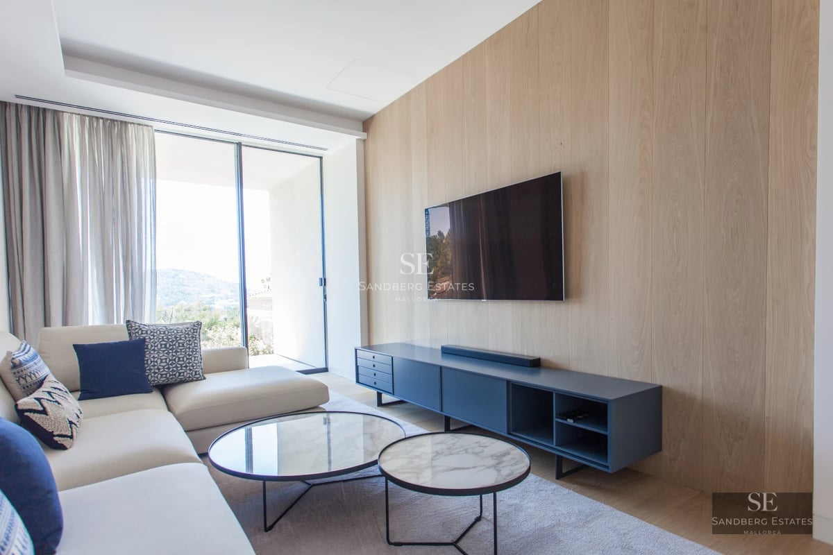 View of infinity pool with sun loungers, palm trees, and clean-lined modern architecture. Minimalist design with wood accents.