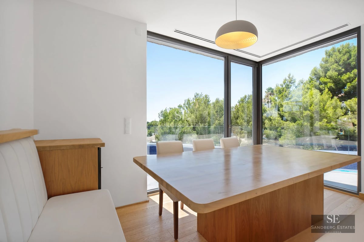 Exterior of a modern villa featuring an infinity pool, lush gardens, and expansive terraces. Elegant architecture and panoramic views.