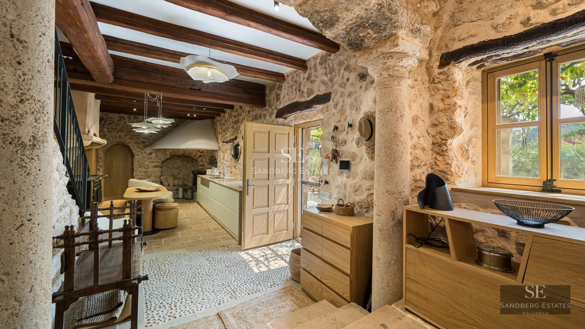 Exterior view of a modern villa with pool, minimalist design, large windows, and lush greenery.