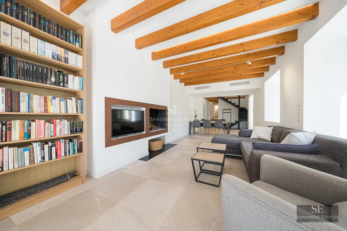 Exterior view of a modern villa with blue pool, surrounded by greenery and large windows. Minimalist architecture.