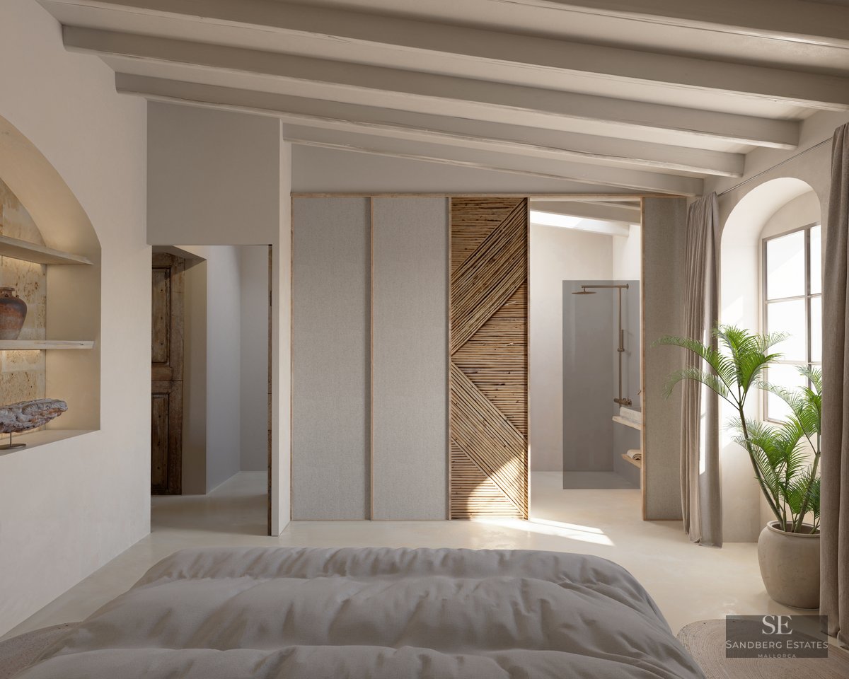 Luxury master bedroom with exposed beams, natural wood textures, and an integrated open-concept ensuite bathroom.