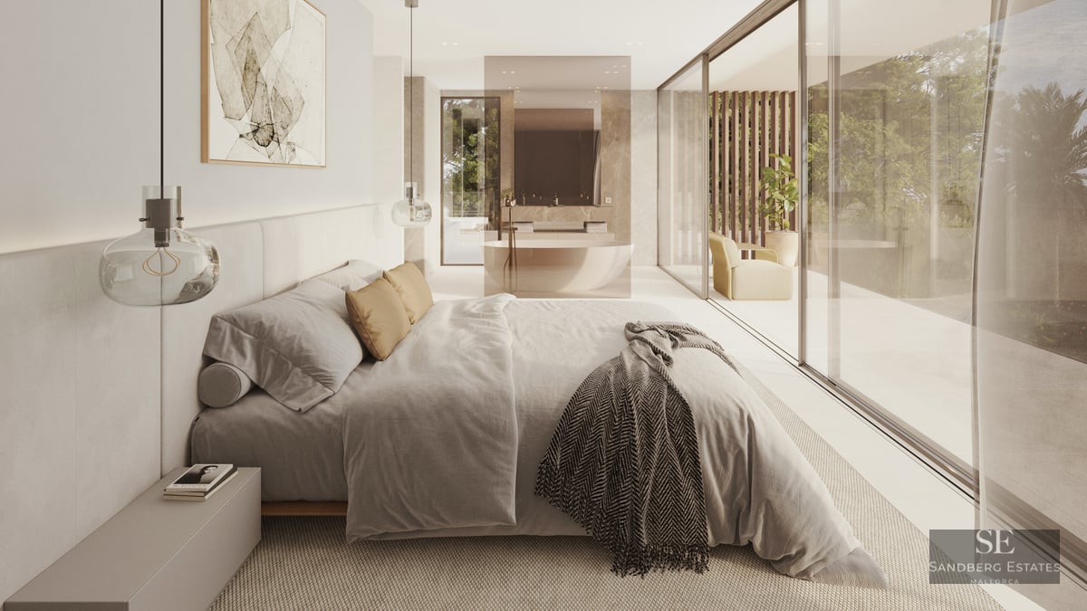 Modern bedroom with a large bed, glass walls showing a terrace, and an open-plan bathroom with a freestanding tub.