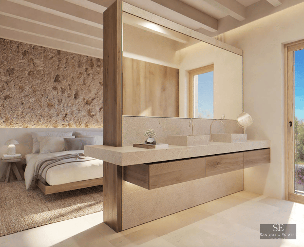 Modern master bedroom with integrated stone double vanity, rustic stone accent wall, and timber-beamed ceiling.