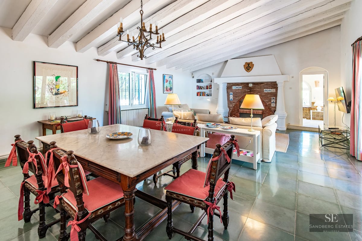 View of infinity pool with lush garden. Modern architecture with large windows and elegant landscaping design.