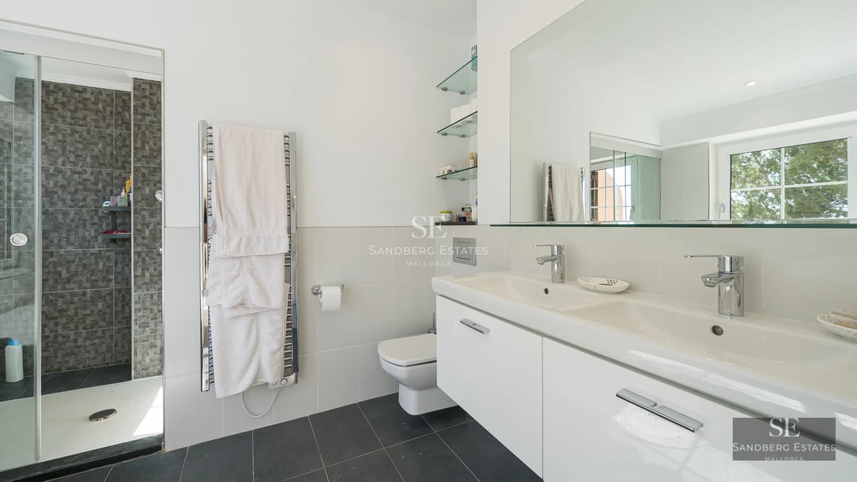 Spacious living room with floor-to-ceiling windows, modern fireplace, and designer furniture. Panoramic views. Abundant natural light.