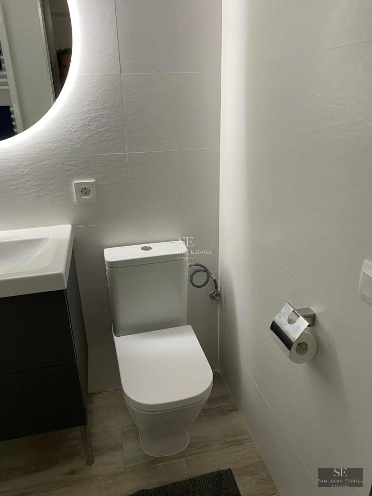 Exterior view of modern home with reflecting pool, lush garden and minimalist architecture. Soft lighting enhances the details.