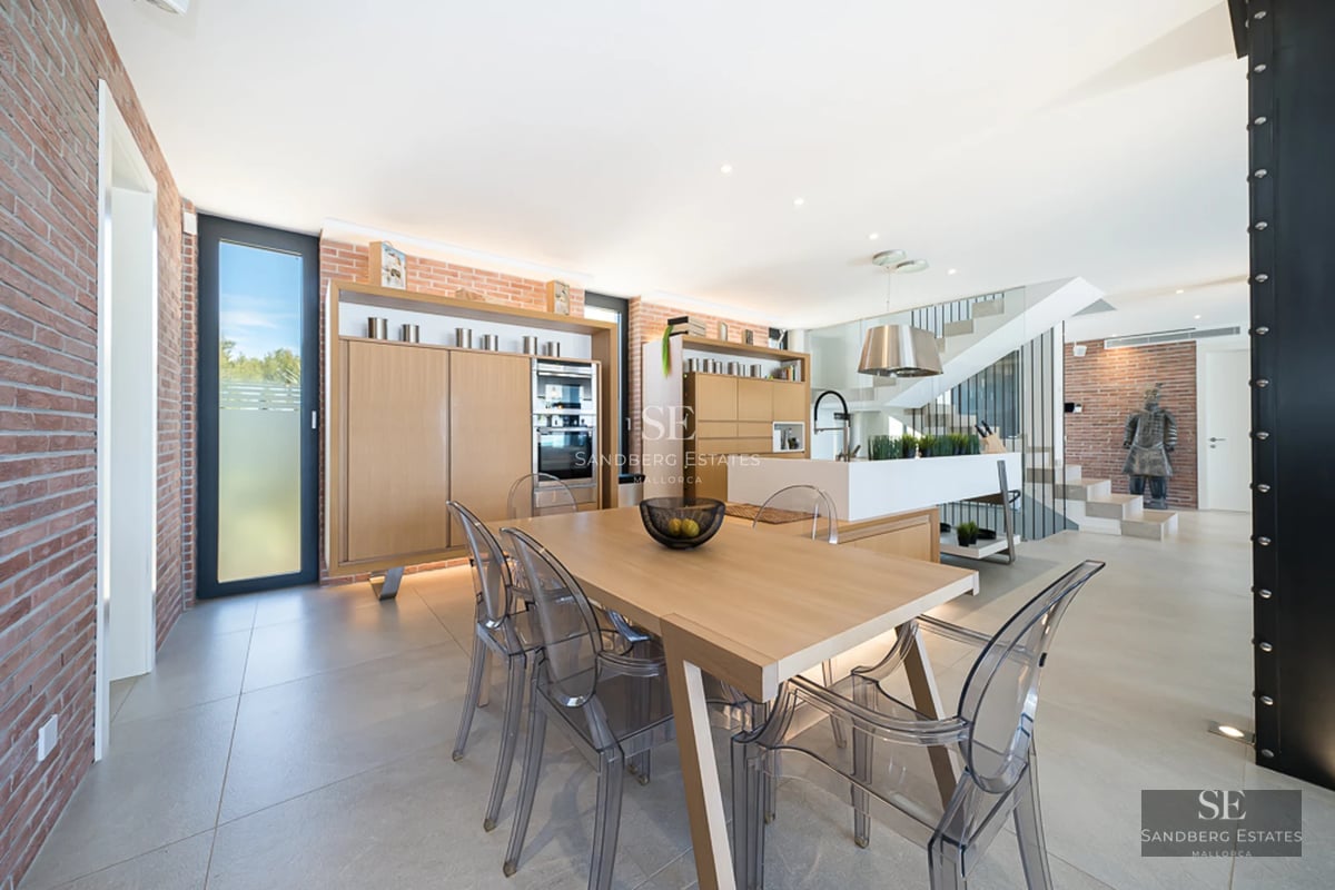 Panoramic view from a luxurious balcony with an infinity pool and sea views. Modern design with elegant furniture and lush vegetation.