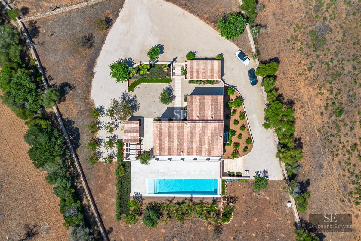 View of a modern villa featuring a swimming pool, garden, and terrace. Minimalist architecture, large windows, and natural light.