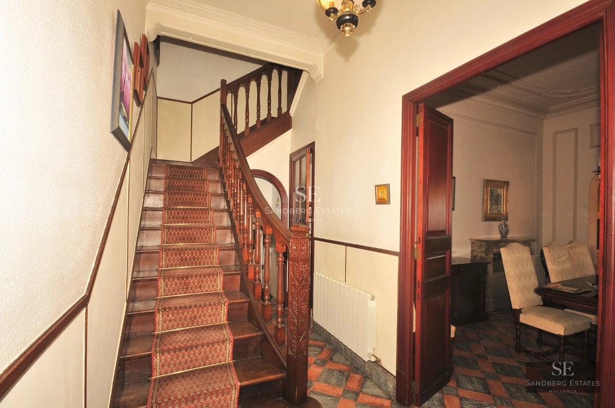 Exterior view of a modern villa with infinity pool, lush garden, and spacious terraces. Minimalist architecture with large window fronts.