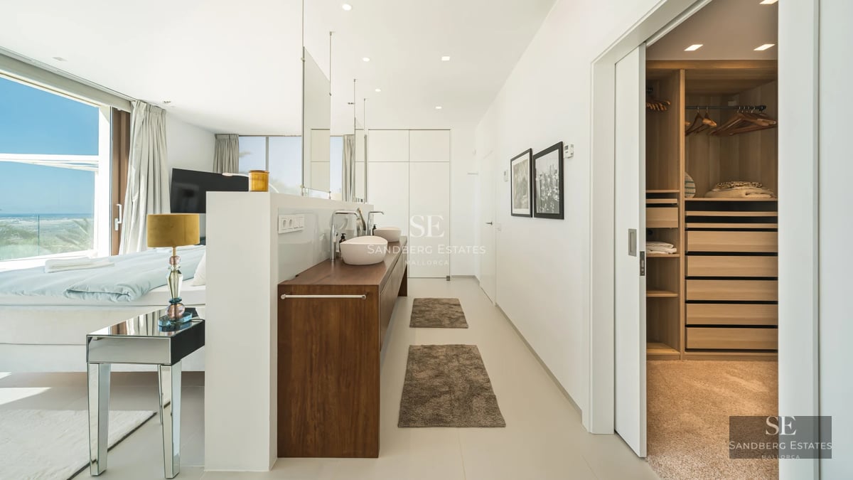 Exterior view of a modern villa with pool, lush gardens, and contemporary architecture.