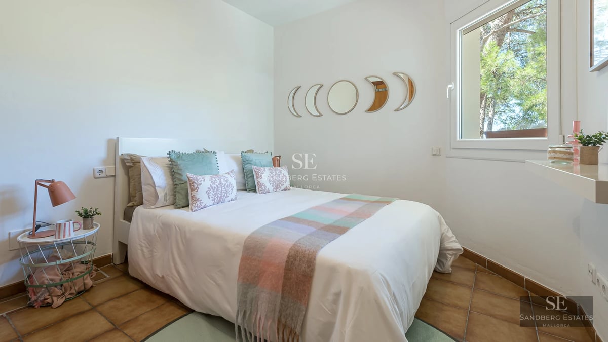 Spacious terrace with infinity pool, stylish sun loungers, and panoramic views. Modern architecture with clean lines and lush vegetation.