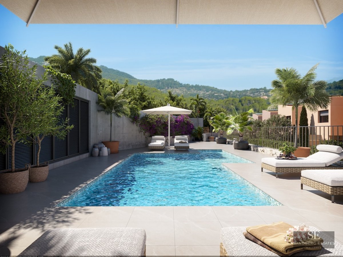 Sun-drenched pool area with white loungers, potted palm trees, and a view of lush green hills under a blue sky.