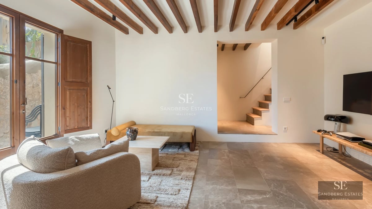 View of modern facade with infinity pool, lush vegetation and blue sky. Minimalist architecture. Stone cladding.