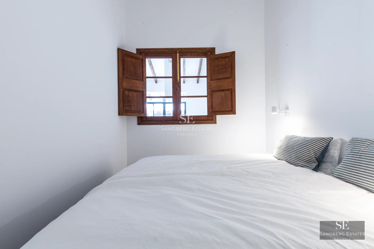 Balcony with glass railing, stunning landscape view, and modern furniture. Minimalist design featuring decorative plants.