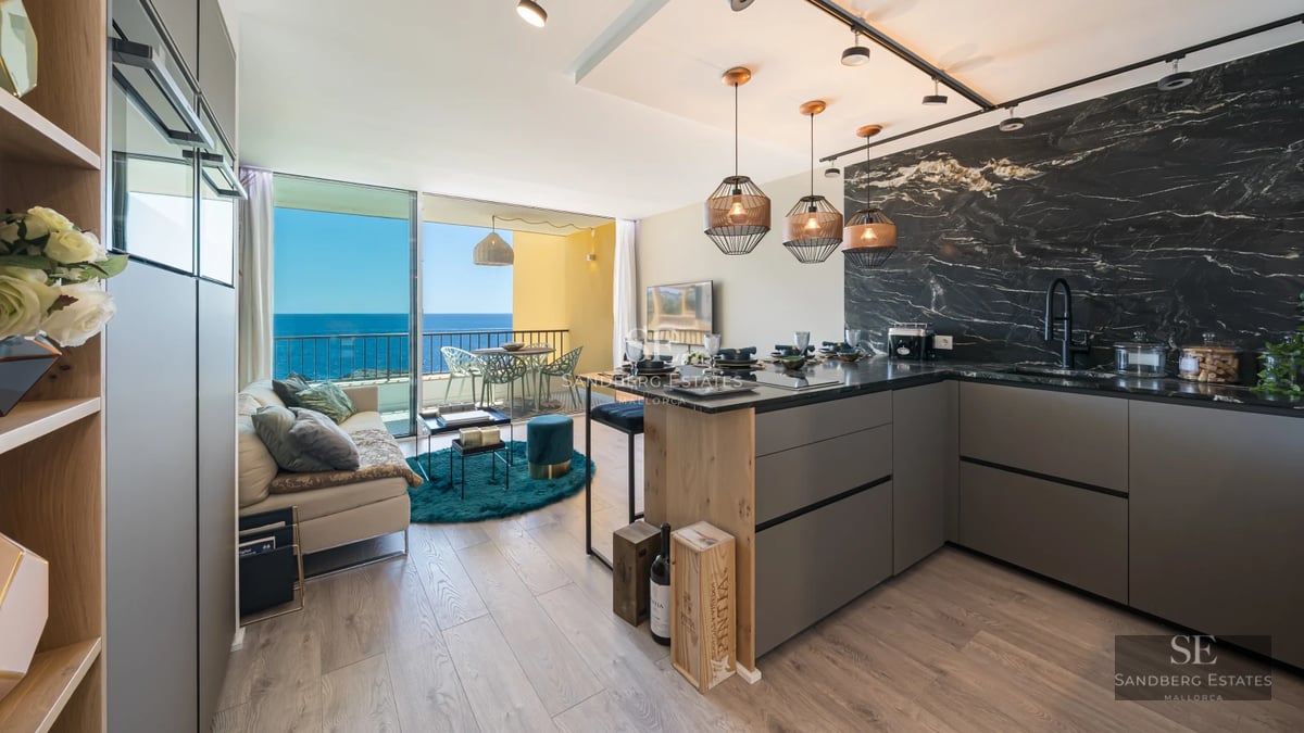 Exterior view of a modern villa featuring an infinity pool, lush garden, and panoramic sea views. Minimalist architecture.