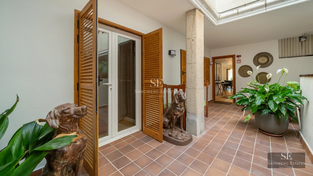 Panoramic view of a modern villa with infinity pool, lush garden, and elegant architectural design.