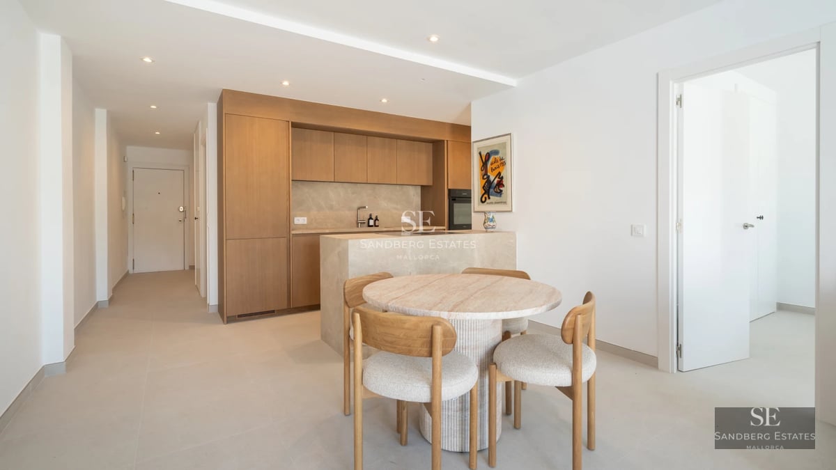 Spacious, bright living room featuring a fireplace, large windows, and access to a terrace with a pool. Modern and elegant design.