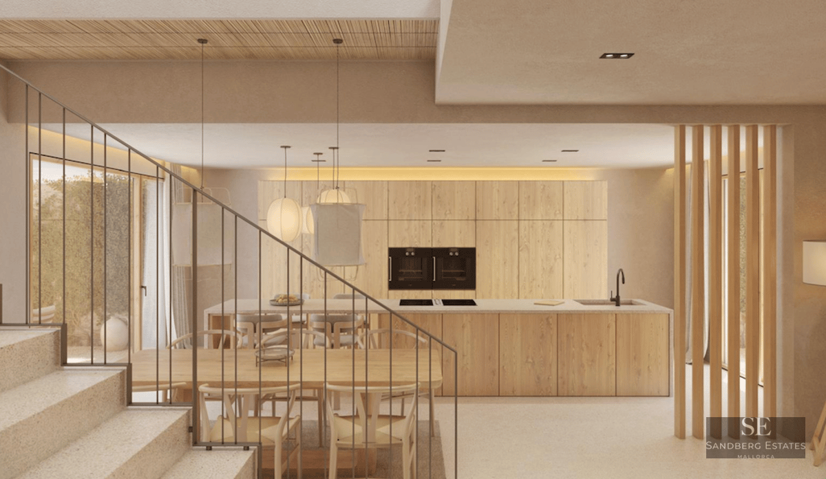 View of a modern kitchen with a wood island, dining area with Wishbone chairs, and a minimalist stone staircase.