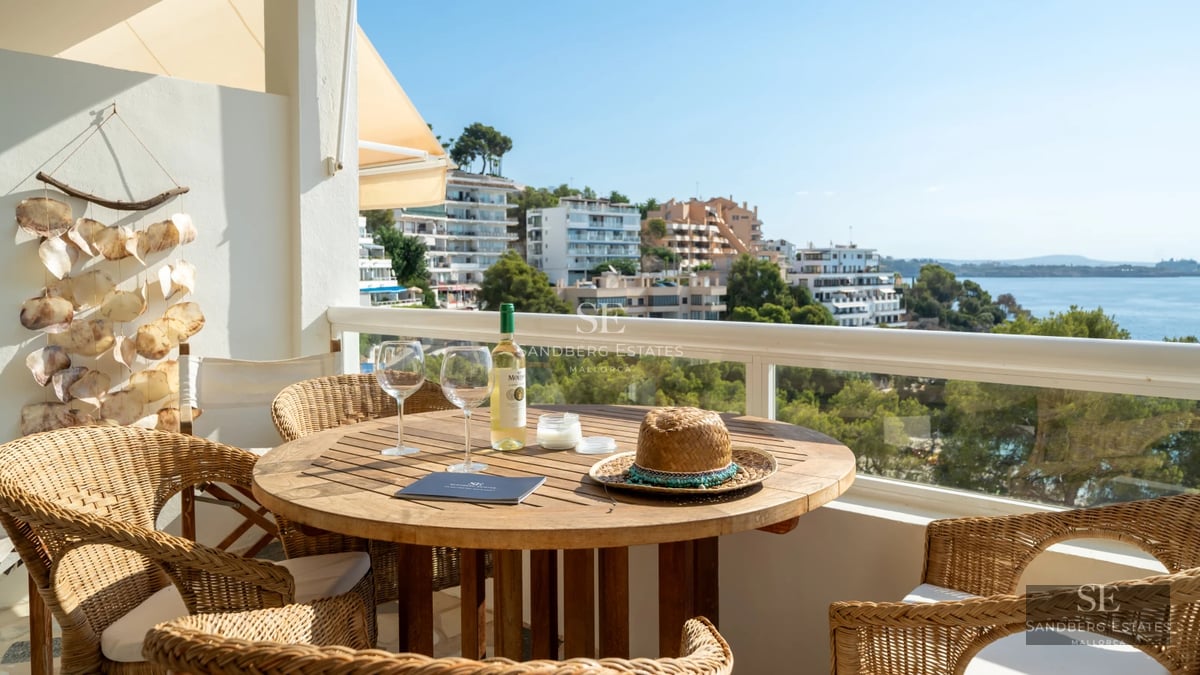 Large pool surrounded by lush greenery. Lounge chairs and umbrellas for relaxation. Modern and elegant design.