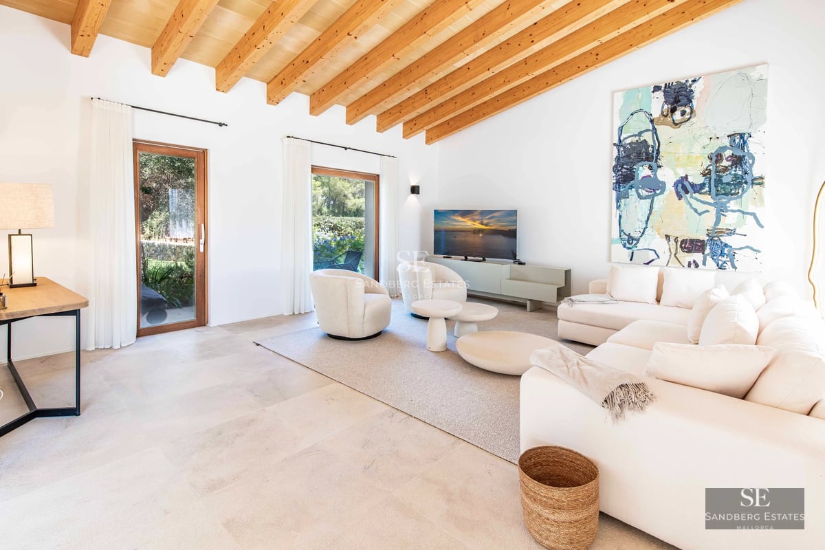 Spacious living room with large windows, designer sofas, stylish coffee table, and panoramic sea views. Bright and modern.