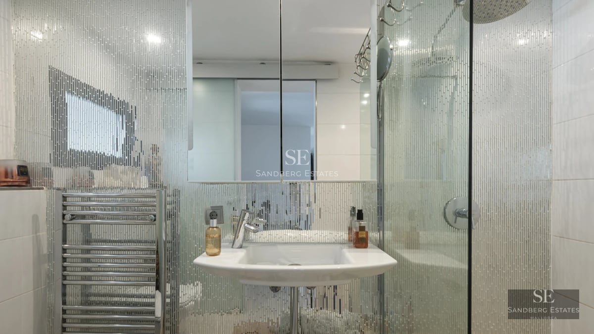 Exterior view of a modern villa featuring a pool, expansive terraces, lush vegetation and contemporary architecture.