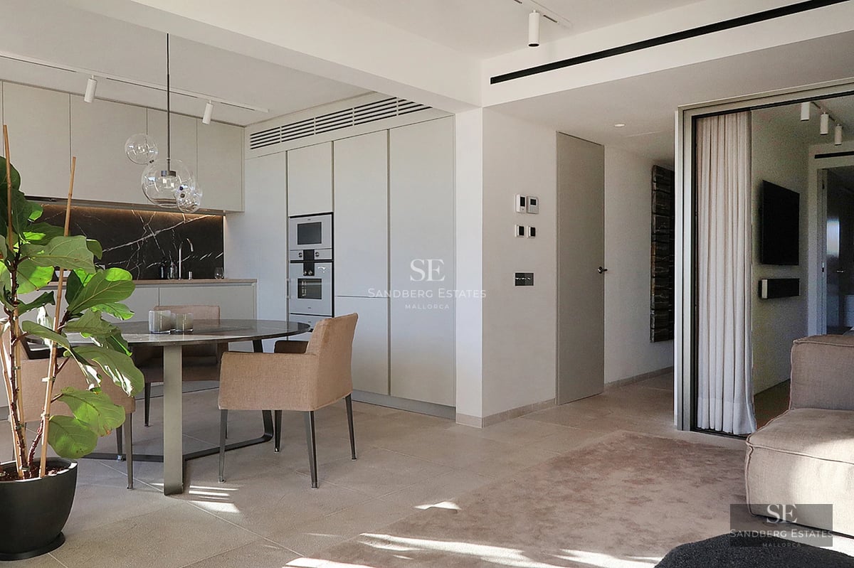 Exterior view of a modern villa with a pool and garden. Large windows, minimalist design, and lush natural surroundings.