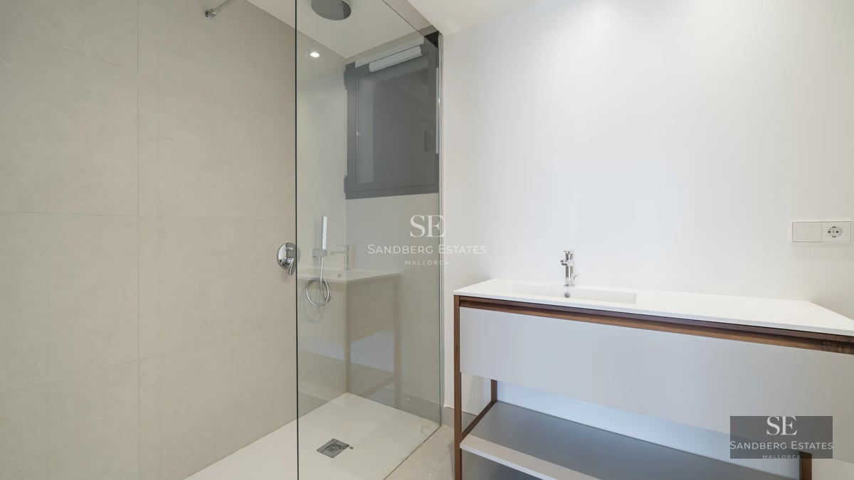 Spacious living room featuring panoramic windows, modern furniture, and balcony access. Breathtaking views. Abundant natural light.