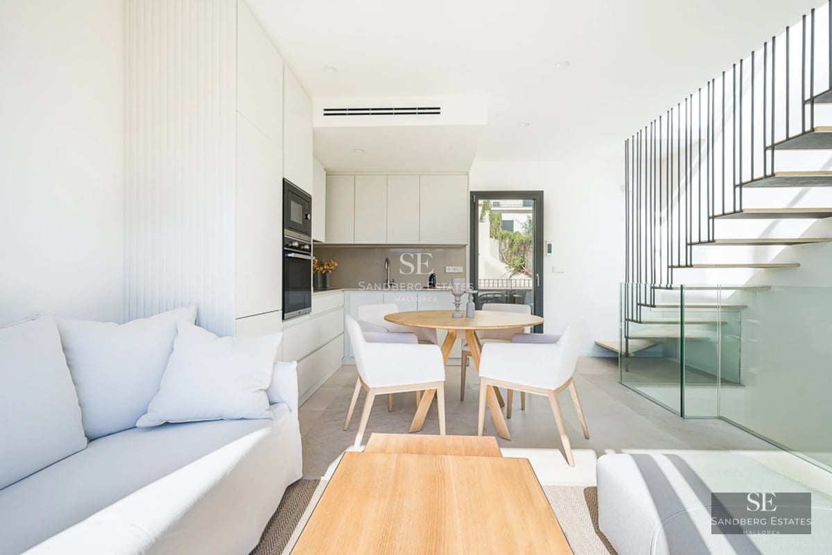 View of a modern villa featuring an infinity pool, lush garden, and large windows. Minimalist architecture and manicured landscaping.