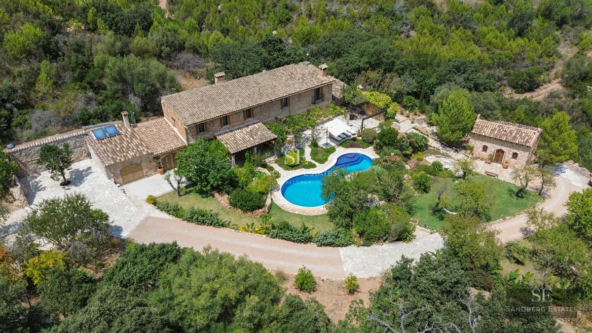 Exterior view of a modern villa with a pool, lush garden, and spacious terraces. Minimalist architecture with large windows.