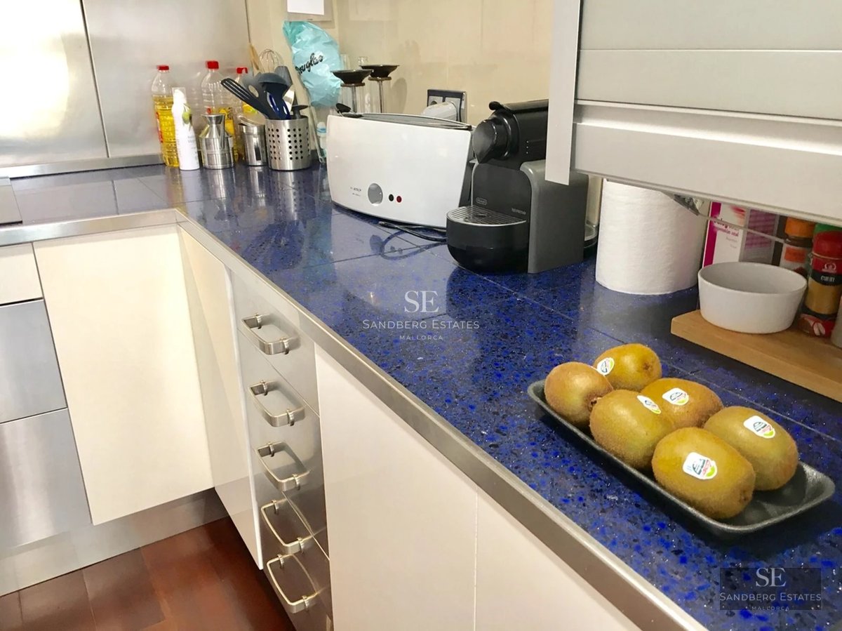 Modern terrace with pool, sun loungers, and panoramic sea views. Elegant furniture and minimalist design with spacious open areas.