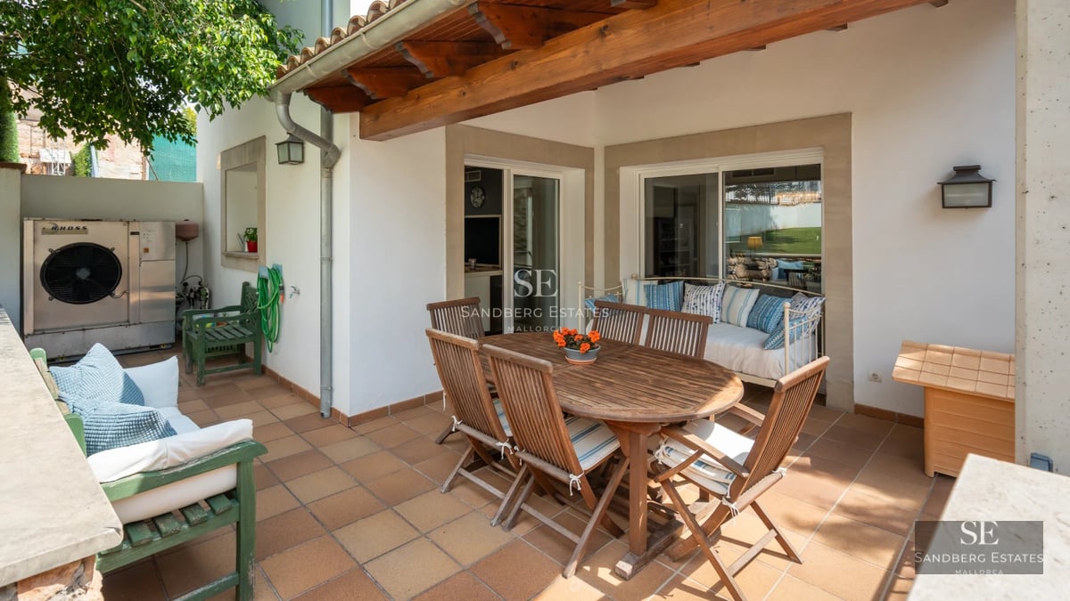 Exterior view of modern villa with infinity pool, lush garden, and large terraces. Minimalist architecture with large window fronts.