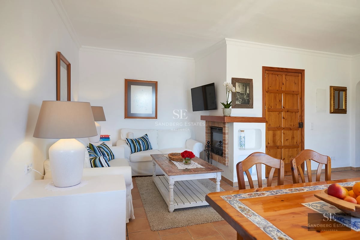 Exterior view of a modern villa with a pool, lush garden, and minimalist architectural design. Large windows and spacious terrace.