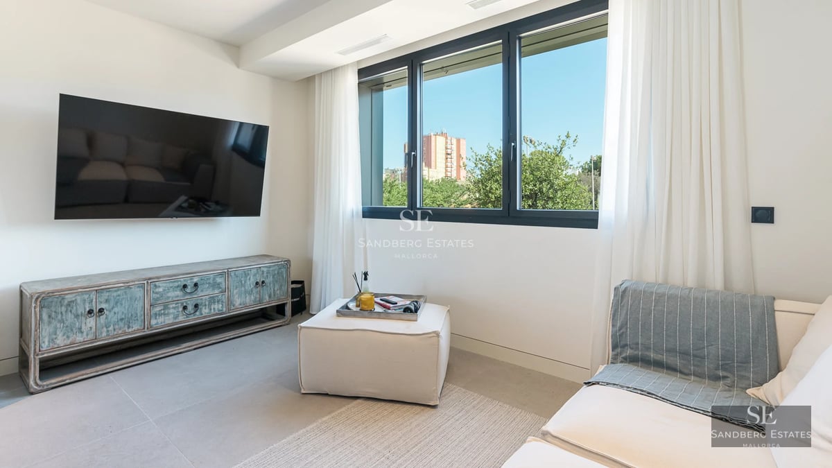 Bright living room with sea view. Large windows, modern design, glazed balcony. Elegant and minimalist interior.