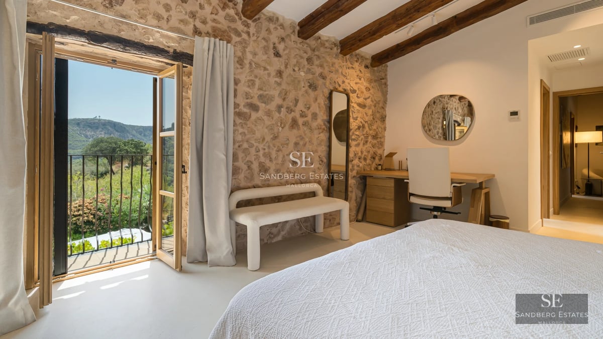 Spacious balcony with sea view. Glass railing, wooden floor and modern furniture. Soft ambient lighting.