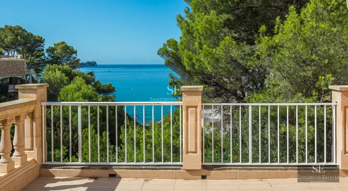 Exterior view of modern villa featuring reflecting pool, lush garden, and expansive terraces. Minimalist design and high-quality finishes.