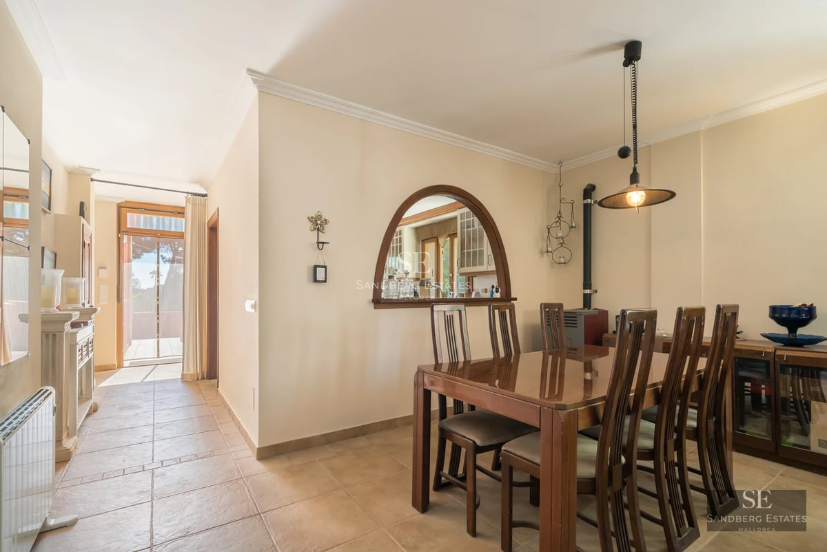 Spacious living room with picture windows, fireplace, leather sofas, and wood floors. Abundant natural light. Modern and elegant decor.