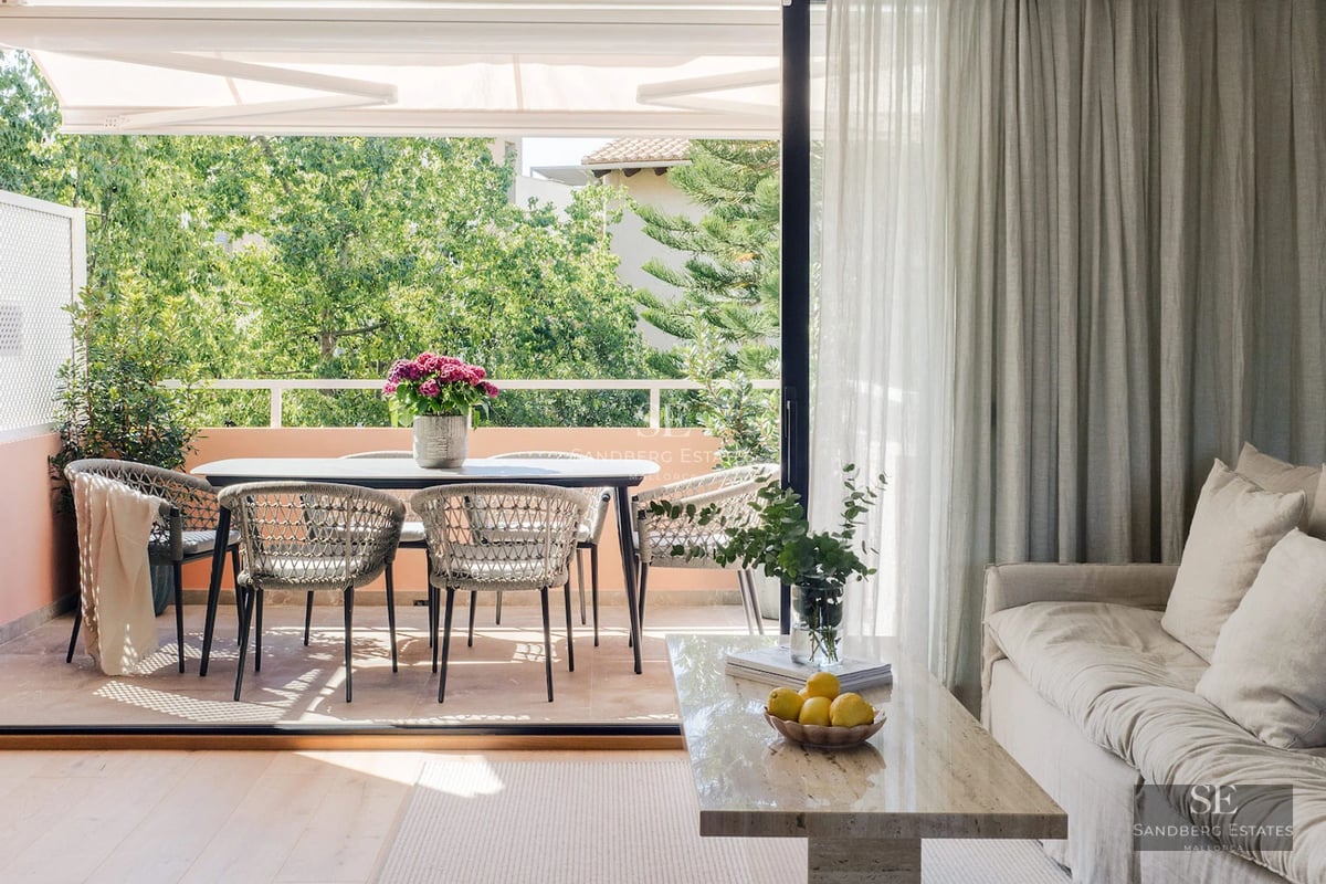 Exterior view of modern villa featuring an infinity pool, lush garden, and minimalist facade with large windows.