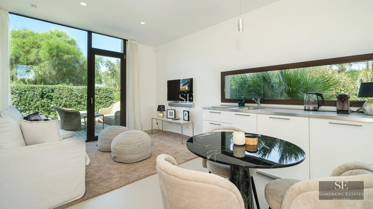 Spacious terrace with infinity pool, sun loungers, and panoramic sea views. Modern design featuring clean lines and lush vegetation.