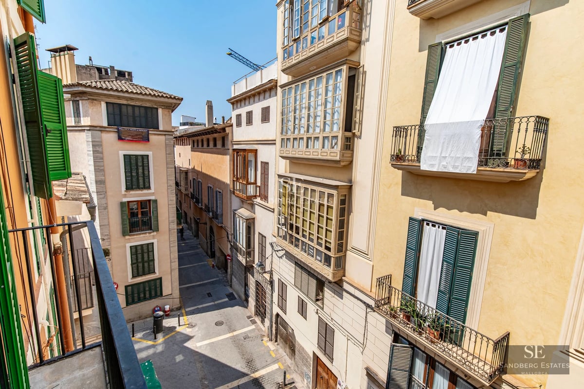 Panoramic view of a modern living room with large windows offering stunning sea views. Minimalist and elegant design.