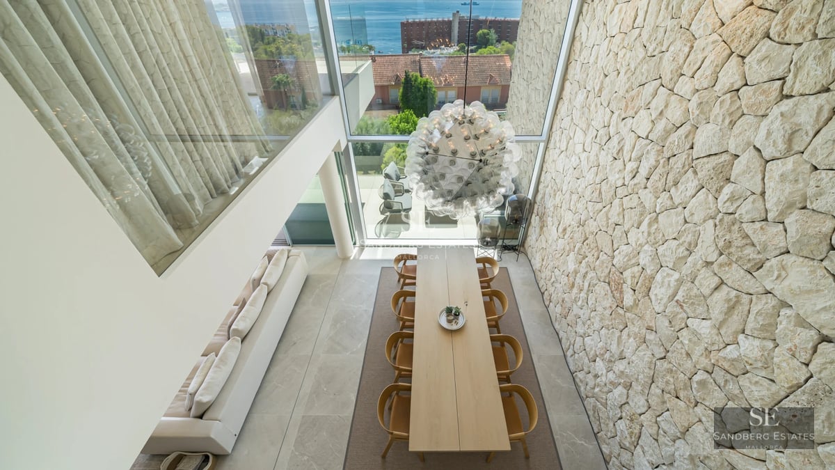 Exterior of modern villa featuring reflective pool, immaculate lawn, and minimalist architectural design.