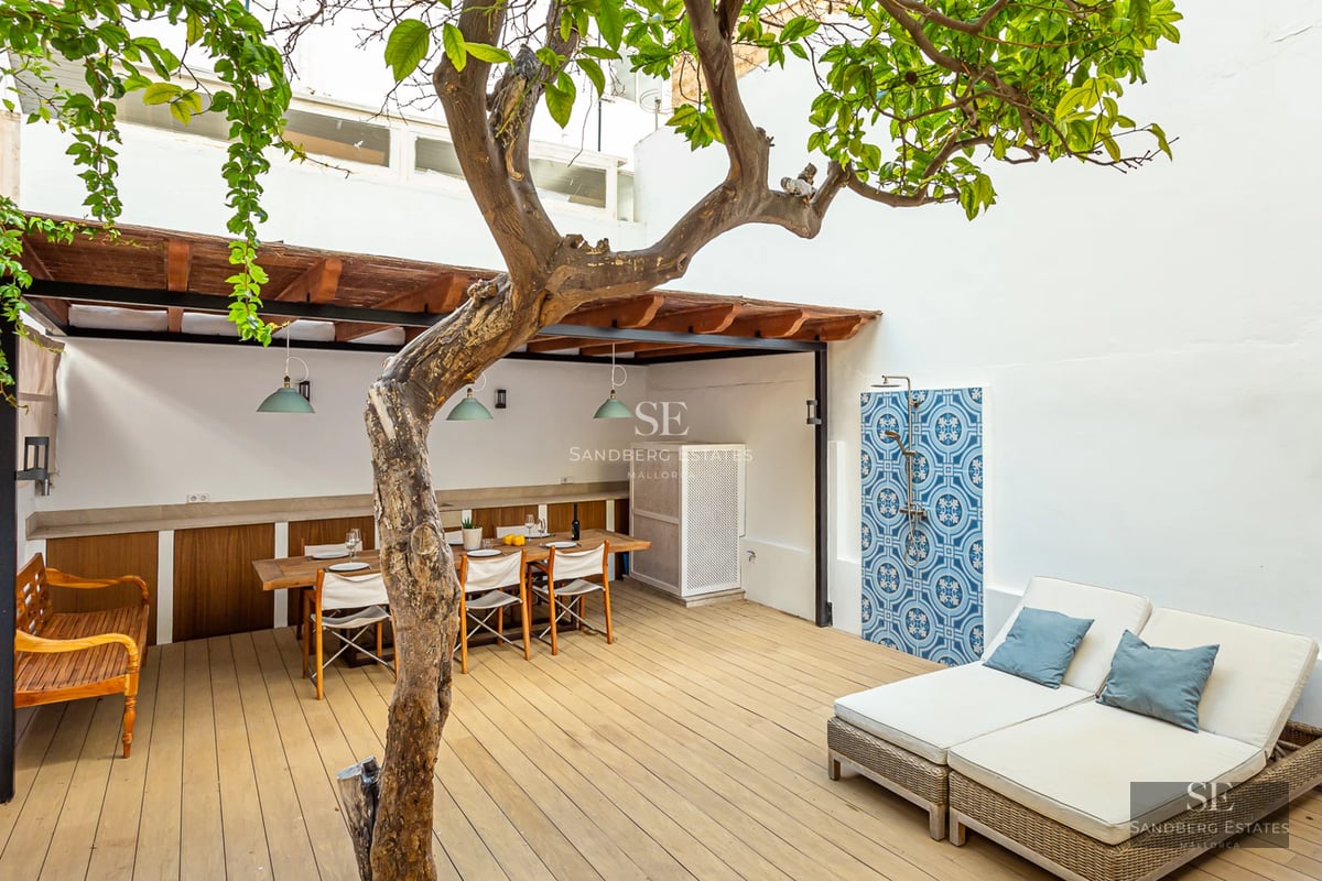 Bright living room with balcony and sea views. Modern design with light wood floors and elegant furnishings. Large windows.