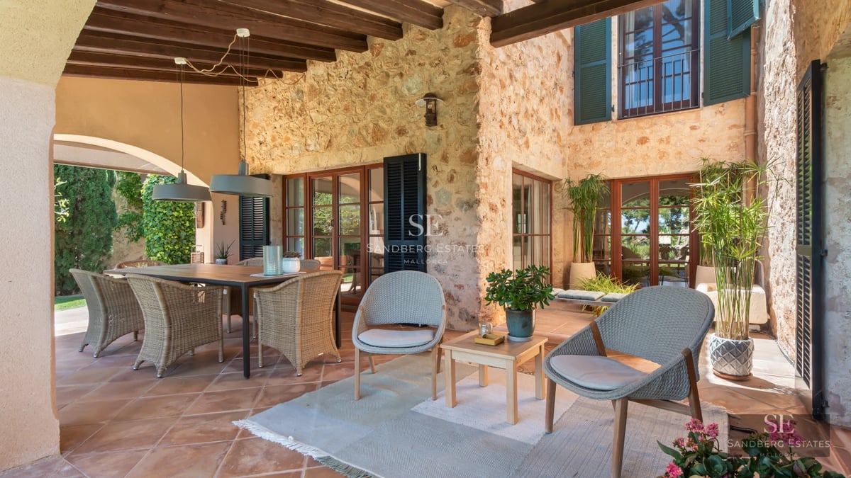 Bright living room featuring large windows offering panoramic sea views. Modern interior design with elegant furniture and light wood flooring.