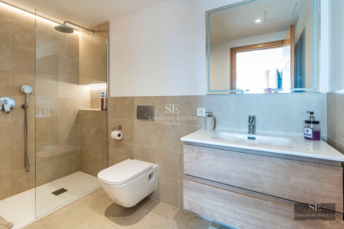 Spacious living room with panoramic windows, light wood flooring, modern fireplace, and designer furniture. Exceptional natural light.