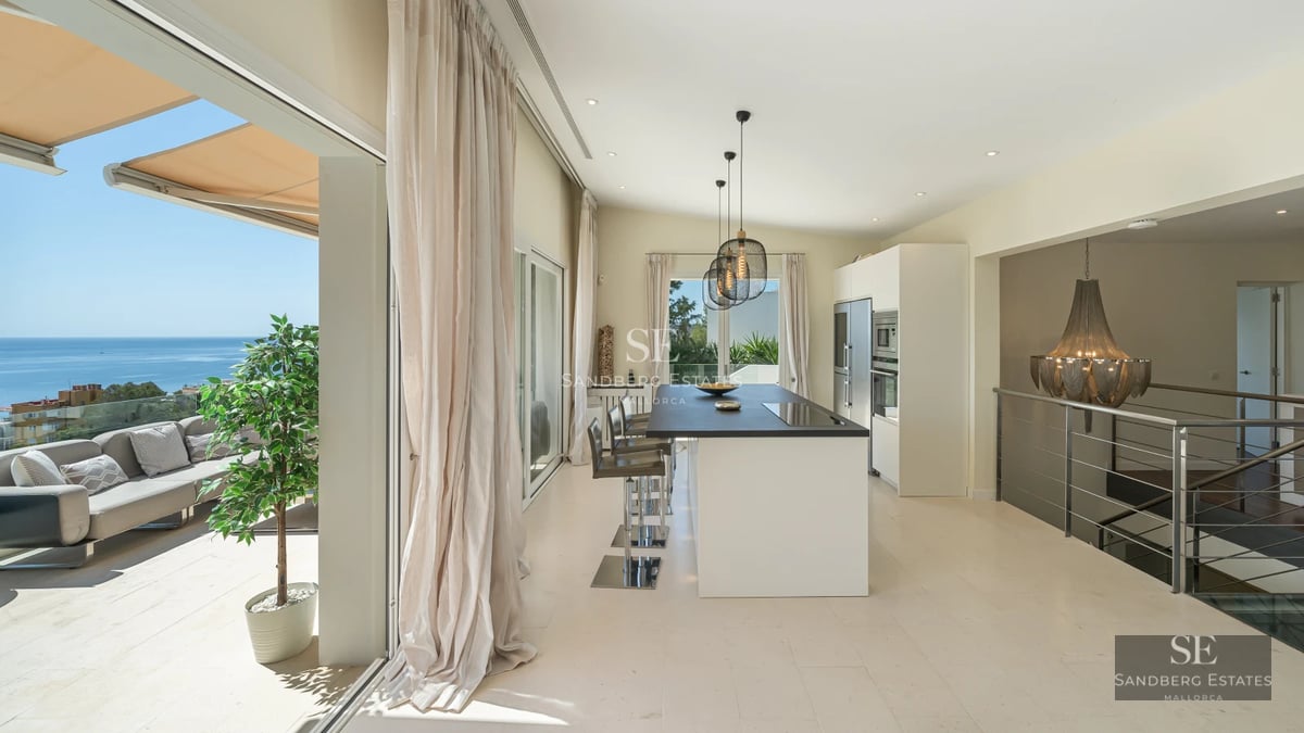 Exterior view of a modern villa featuring a pool, sun loungers, and greenery. Sleek, minimalist design with large windows and natural textures.