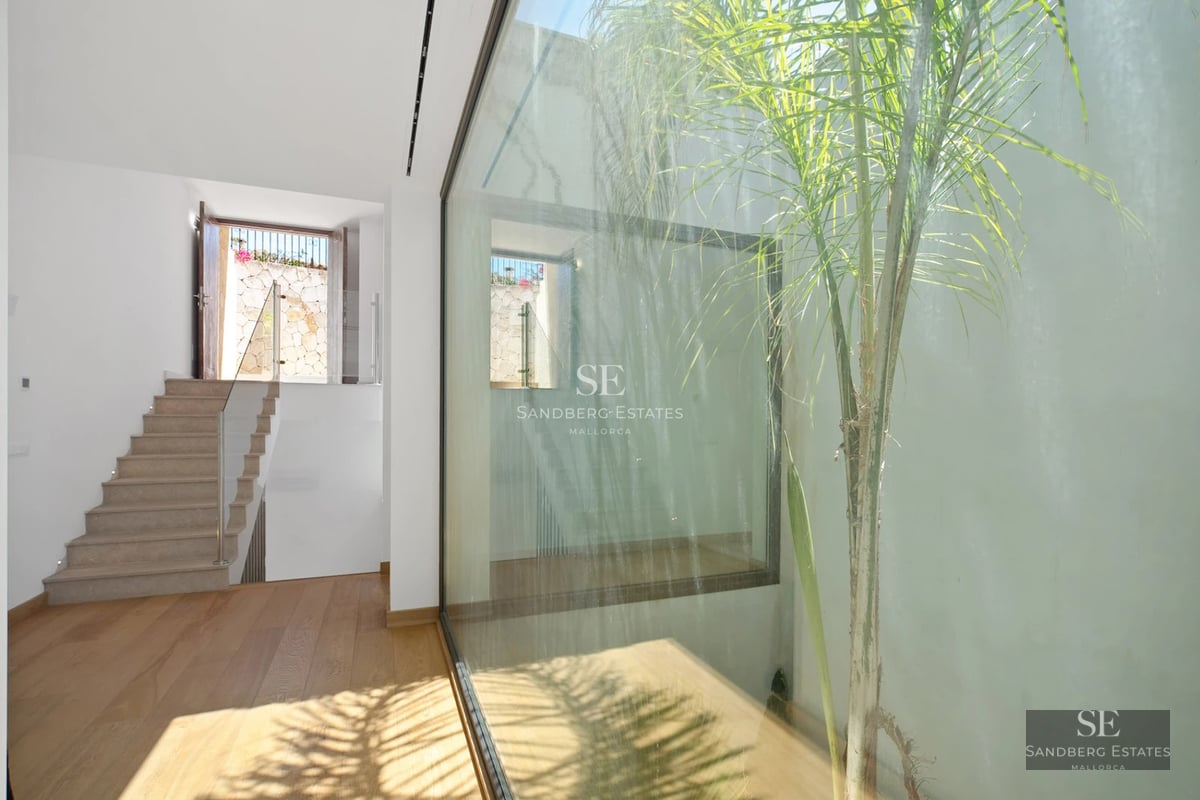 Exterior view of a modern luxury villa featuring a pool, lush garden, and large windows. Minimalist design with high-quality finishes.